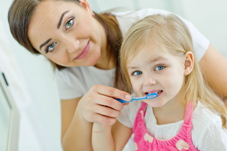 Mom and Daughter brushing their teeth - Pediatric Dentist in Columbus, OH